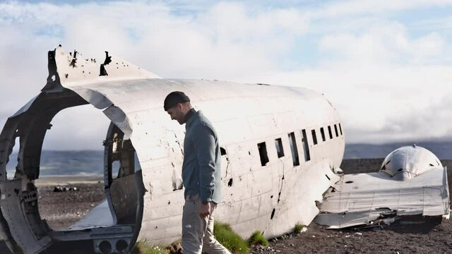 Landscape Shot of Male Model Walking Outside the Solheimasandur Plane Wreck