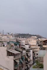 Obraz premium Cityscape of residential area in Athens at evening twilights. Urban architecture. Mountain on background.