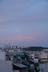 Cityscape of residential area in Athens at evening twilights. Urban architecture. Mountain on background.