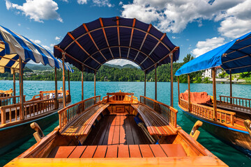 Fototapeta na wymiar Traditional Boats on Bled Lake in Slovenia on Summer Day