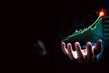 Businessman hand holding increasing virtual investment graph and chart for stock market analysis...