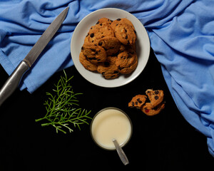 Chocolate biscuits with chocolate chip topping as snacks in the morning, are very popular among children to old age. Biscuits and milk are the perfect combination of food and drink. Biscuit mockup.