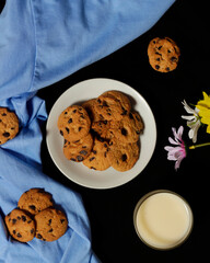 Chocolate biscuits with chocolate chip topping as snacks in the morning, are very popular among children to old age. Biscuits and milk are the perfect combination of food and drink. Biscuit mockup.