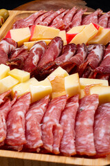 Cold cuts board with salami and different types of cheese