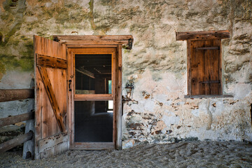 Fototapeta na wymiar View of a door and a window with shutters on an old building in Batsto village, located in the Pine Barrens, New Jersey, USA