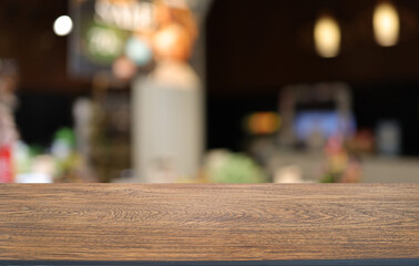 Empty wooden table in front of abstract blurred background of coffee shop . can be used for display or montage your products.Mock up for display of product