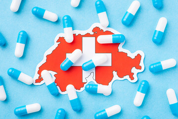 Map of Switzerland with many pills around. Symbol of bad medical condition in the country, spread of many illnesses and diseases