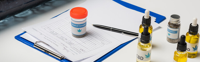 clipboard with prescription near medical cannabis medication on white desk, banner