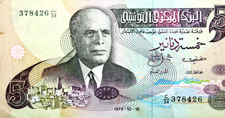 Obverse side of 5 five Tunisian dinars banknote issued 1973 by the central bank of Tunisia with a portrait of president Habib Bourguiba and the Sousse medina and 3 row boats along shore, vintage retro - obrazy, fototapety, plakaty