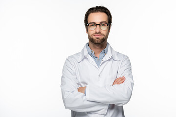 Serious doctor standing with crossed arms isolated on white