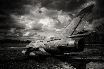 old abandoned airplane in field, dramatic sky, spring evening