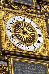 Gilded Conciergerie clock hang on the Clock Tower of the Conciergerie in Paris