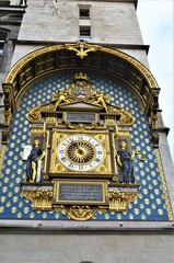 Gilded Conciergerie clock hang on the Clock Tower of the Conciergerie in Paris