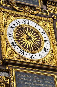 Gilded Conciergerie clock hang on the Clock Tower of the Conciergerie in Paris