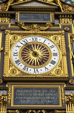 Gilded Conciergerie clock hang on the Clock Tower of the Conciergerie in Paris