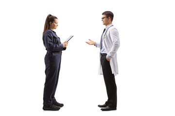 Full length profile shot of a male doctor talking to a female auto mechanic worker - Powered by Adobe
