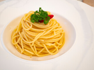 dish of spaghetti aglio olio e peperoncino, Italian recipe based on garlic oil and hot chilli pepper. Gourmet dish photography still life food