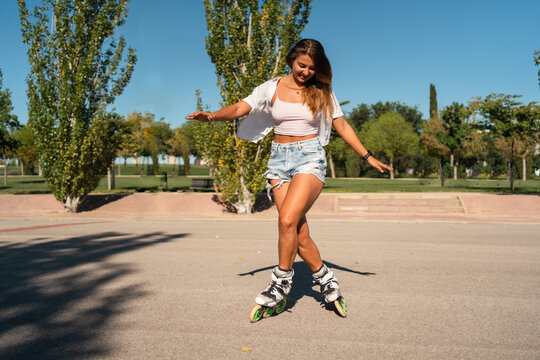 Woman in rollerblades and showing stunt