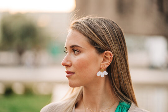 Tender woman in stylish jewelry in city
