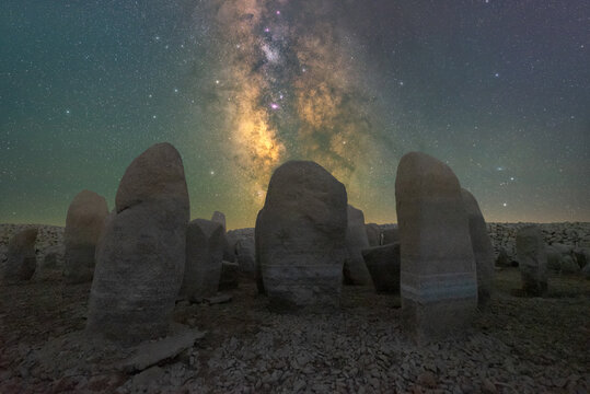 Megalithic monuments under starry sky with Milky Way