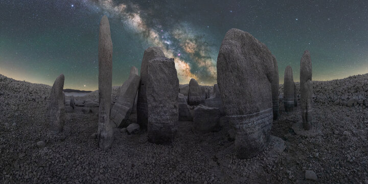 Megalithic monuments under starry sky with Milky Way