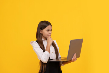 concentrated serious teen girl in school uniform study on laptop, knowledge