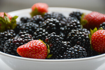 blackberries and strawberries on a plate
