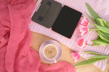 flatley on a light background, buds of spring flowers, pink tulips, a cup of cappuccino, e-book, phone with a blank screen, concept of spring, women's lifestyle