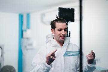 Naklejka premium Scientists wearing uniform protection. Check the manufacturing process of face masks. In a laboratory at industry plants. The concept for security and protection coronavirus covid-19.
