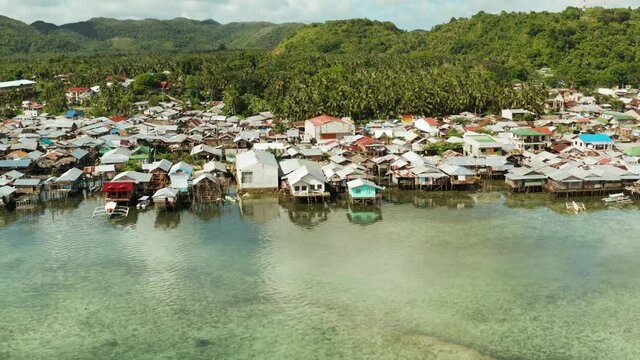 Village of stilt houses built over the sea, top view. Dapa, Siargao, Philippines.