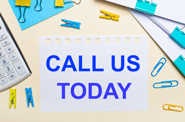 On a light background, there are stacks of documents, a white calculator, yellow and blue paper...