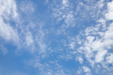 The background image of a beautiful blue sky with some white clouds in the daytime.