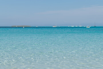 Sailing boats visit la Pelosa Beach