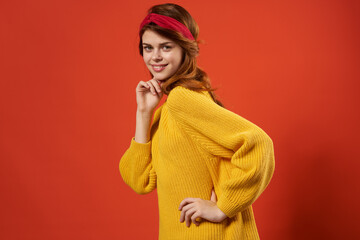 woman in yellow sweater with bandage on her head fashion red background studio