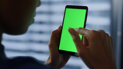 Businesswoman using mobile phone with green screen. Woman chatting on cellphone 