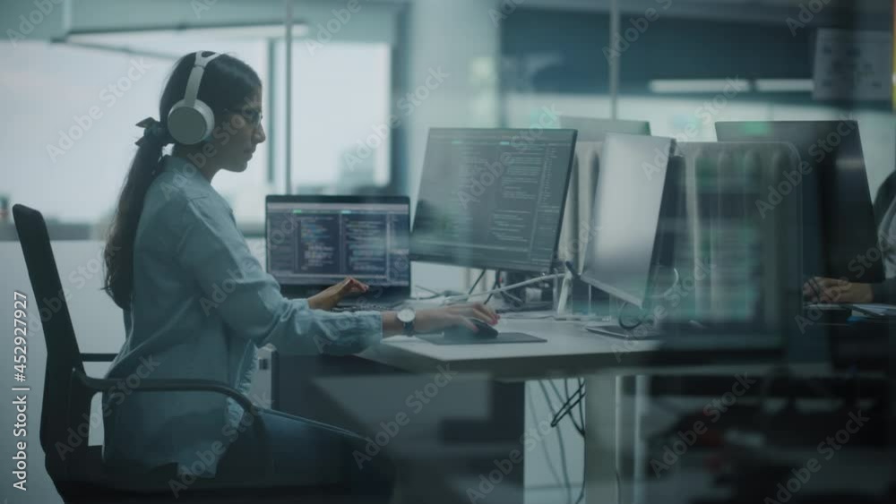 Poster Diverse Office: Indian IT Programmer Working on Computer. Female Specialist Creating Innovative Software. Engineer Developing App, Program, Video Game. Wearing Headphones Listening Podcast, Music