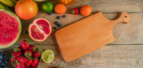 Fresh fruits on a wooden background with copy space, colorful fruits. Food concept. Copy space