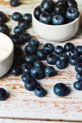Ripe blueberries on a wooden shabby table with an estimate in a close-up