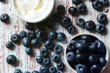 Blue berry with sour cream, in a close-up on a wooden table top view