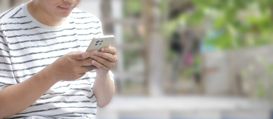 Happy Asian man smile and using or holding smartphone with one hand.