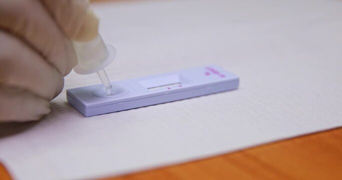 Closeup shot of doctor hand pressing drop test