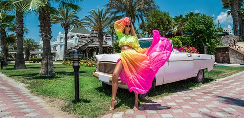 Rolgordijnen Havana Summer fashion. Beautiful sexy blonde woman in colorful dress near the pink car on Cuba Havana. Spring and summer fashion model concept. Vintage and retro style. Luxury travel.