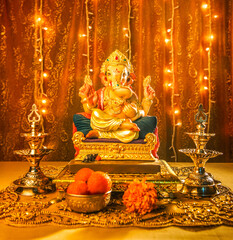 Ganesha idol against decorated background. Clear space for text on the poster or greeting card for Ganesh Festival.