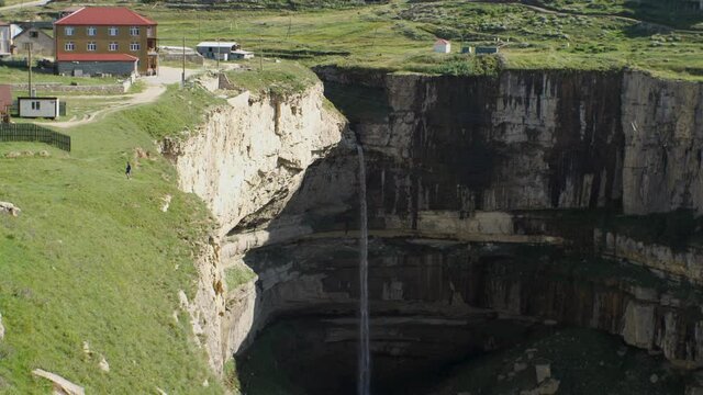 A stream of water falls from a great height into a stone bowl. Tobot waterfall Republic of Dagestan, Russia. The concept of traveling in your country