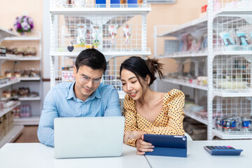 Business owners. Male and female successful small business owners sit down to discuss account balances, trade information, coffee shops, bakery, and convenience stores.
