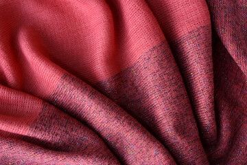 Texture of a female pink scarf. Woolen fabric. Pink knitted fabric background.