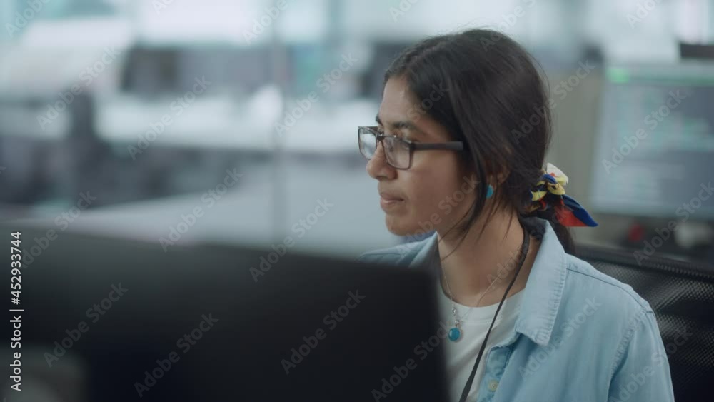 Poster diverse office: portrait of beautiful indian it programmer working on desktop computer. female speci