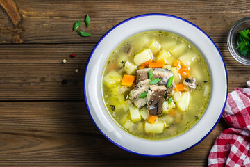 Ukha, canned fish soup on wooden rustic background. Space for text, top view.
