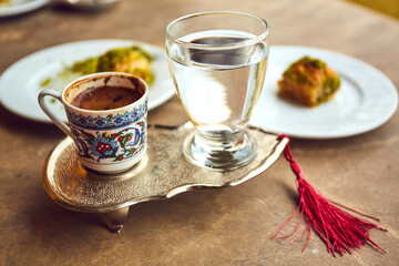 Turkish coffee and turkish delight with traditional embossed metal tray and cup