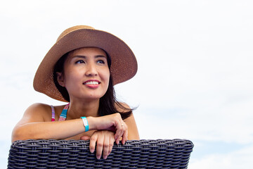 beautiful woman leaning on the beach chair